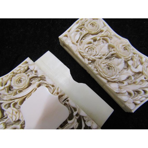 115 - A late 19c ivory card case carved in high relief with panels of leaf and flowers, and through the re... 