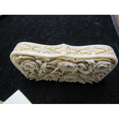 115 - A late 19c ivory card case carved in high relief with panels of leaf and flowers, and through the re... 