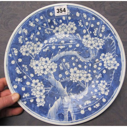 354 - A 19c Chinese blue and white circular dish decorated with Prunus blossom, 29cms dia.