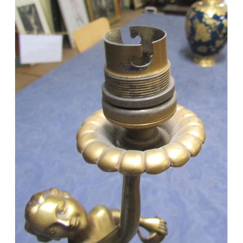 64 - An art deco gilt metal dancing figure table lamp supported on stepped marble base, electrolier.  The... 