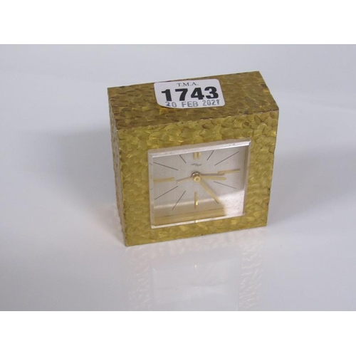 1743 - IM HOF BEDROOM ALARM CLOCK WITH SWISS MOVEMENT IN A GILT METAL CASE 7.5cms SQ