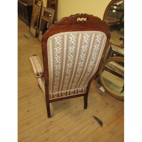 2133 - 19c MAHOGANY CARVED SHOW FRAMED AND UPHOLSTERED OPEN ARMCHAIR WITH SCROLLING ARMS ON CASTORS 116cms ... 