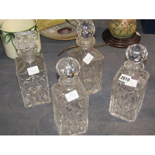 2010 - FOUR CRYSTAL SQUARE FACED DECANTERS AND STOPPERS, ALL APPROX 27CM H