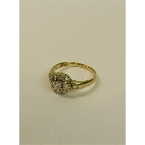 111 - An 18ct yellow gold ring in a daisy design set with old cut diamonds - ring size O