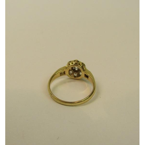 111 - An 18ct yellow gold ring in a daisy design set with old cut diamonds - ring size O