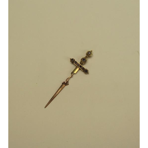 132 - A gold (not tested) sword shaped pin brooch with a applied filigree decoration and set with cut sapp... 