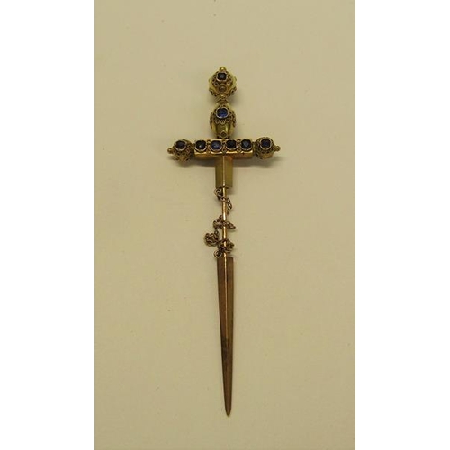 132 - A gold (not tested) sword shaped pin brooch with a applied filigree decoration and set with cut sapp... 