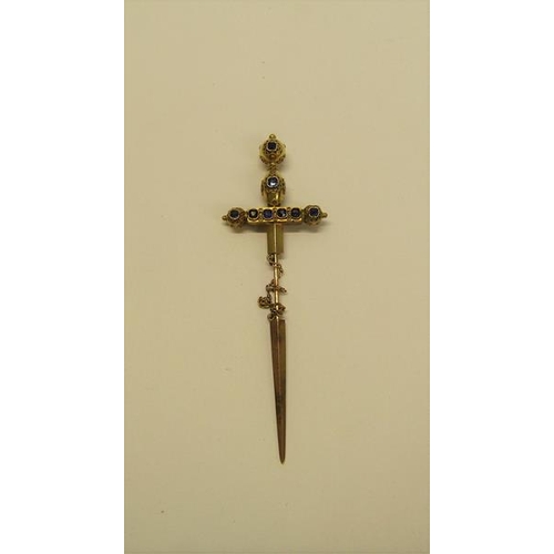 132 - A gold (not tested) sword shaped pin brooch with a applied filigree decoration and set with cut sapp... 