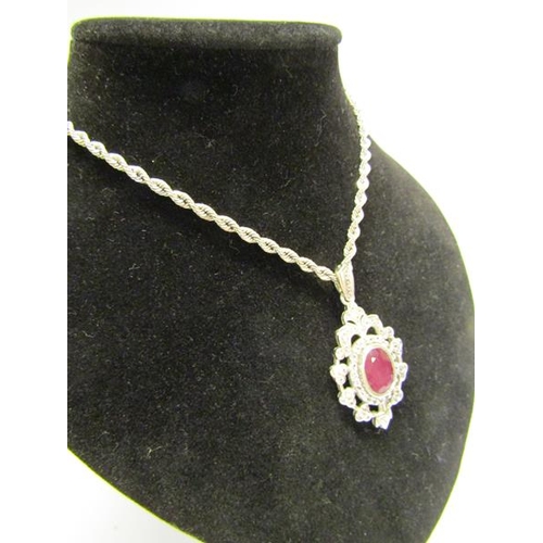 154 - A white gold diamond and ruby set pendant brooch with a chain, total 15.4g, chain 50cm l.