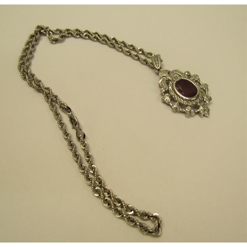 154 - A white gold diamond and ruby set pendant brooch with a chain, total 15.4g, chain 50cm l.