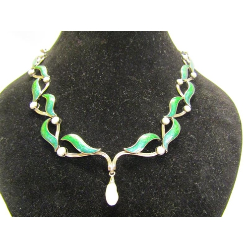 159 - An 18ct white gold necklet and matching earrings designed Britt Marie Darracott and being of green e... 