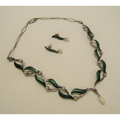 159 - An 18ct white gold necklet and matching earrings designed Britt Marie Darracott and being of green e... 