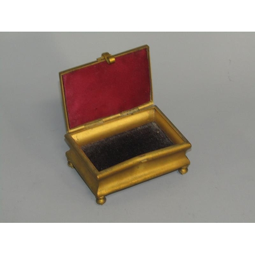 36 - A late 19c gilt metal casket of rectangular shaped form supported on four short beaded legs with a h... 