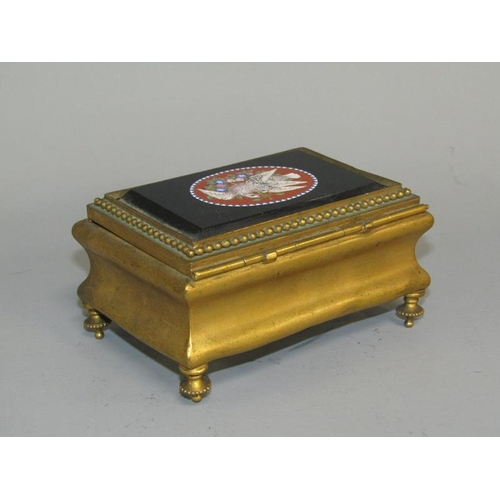 36 - A late 19c gilt metal casket of rectangular shaped form supported on four short beaded legs with a h... 