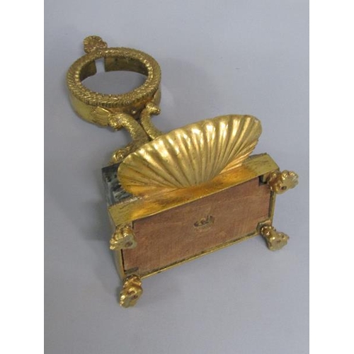 37 - A Regency period gilt metal and marble watch stand, the watch case is supported by two dolphins on a... 