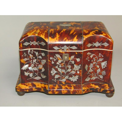 38 - A late Georgian tortoiseshell two compartment tea caddy of serpentine form, the front panels with mo... 