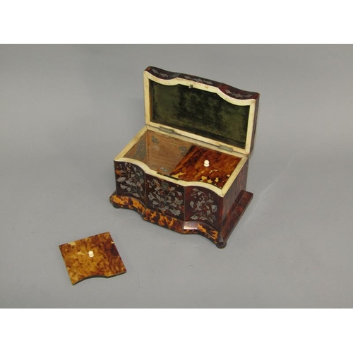 38 - A late Georgian tortoiseshell two compartment tea caddy of serpentine form, the front panels with mo... 