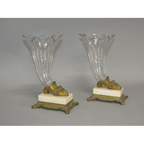 39 - A pair of early 19c rams head cornucopia, the cut clear glass vases supported by gilt metal rams hea... 