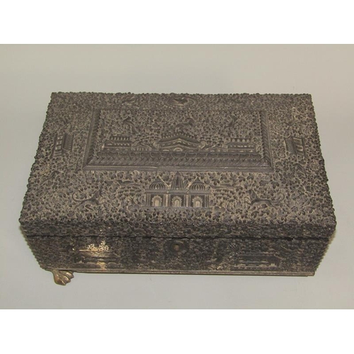 60 - A 19c Indian ebony needlework box, profusely carved in relief with flowers, animals and buildings, t... 