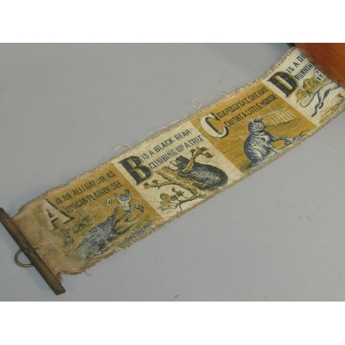 66 - A late 19c/early 20c painted silk alphabetical winding roller, the descriptions when joined forming ... 