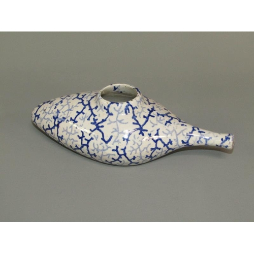 269 - A 19c oval blue and white feeding bottle with seaweed decoration, 19cm l.