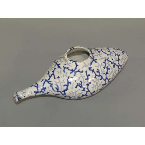 269 - A 19c oval blue and white feeding bottle with seaweed decoration, 19cm l.