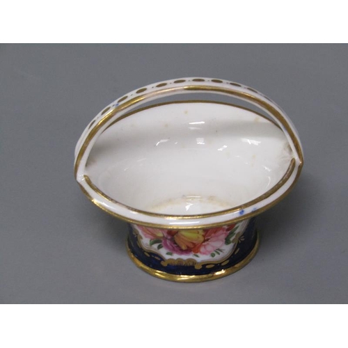 273 - An early 19c porcelain basket painted with floral reserves on a dark blue ground and having gilt lin... 