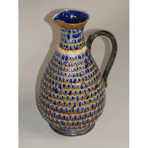 290 - A late 19c Doulton Lambeth stoneware jug with incised scale decoration and applied beadwork, 26cm h.