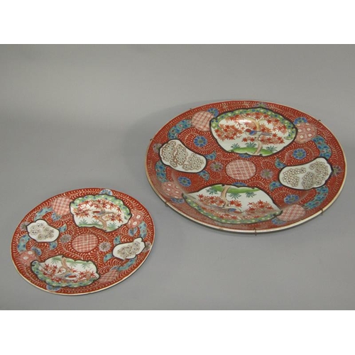 262 - A Meiji period Imari pattern charger decorated in red with birds in blossom and blossom panels, with... 