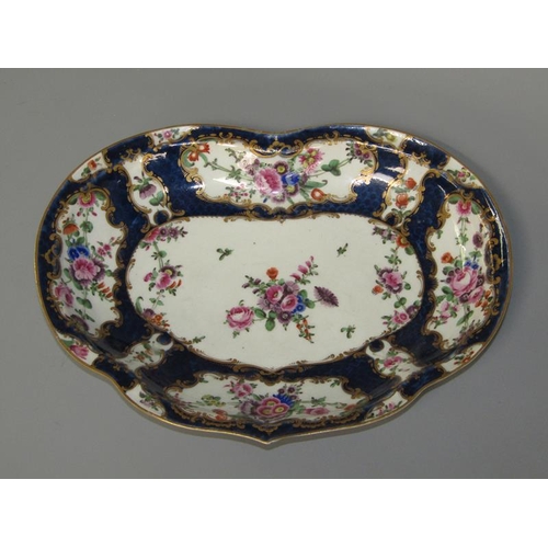 276 - A first period Worcester kidney shaped dessert dish, the scale blue ground wide border painted in re... 