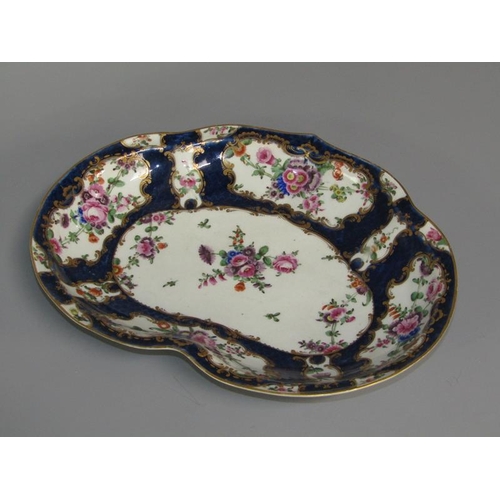 276 - A first period Worcester kidney shaped dessert dish, the scale blue ground wide border painted in re... 