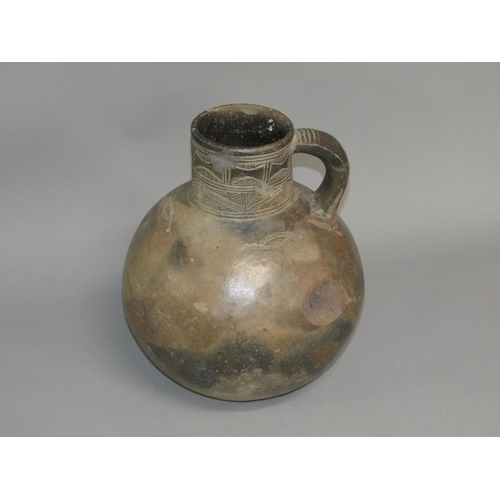 286 - A Medieval pottery jug with incised neck decoration and simple motifs to the shoulder, partially gla... 