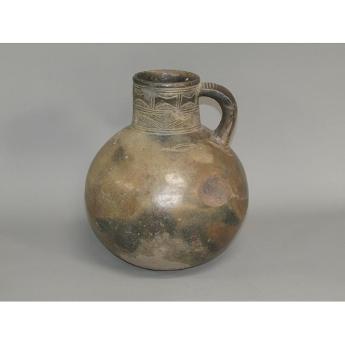 286 - A Medieval pottery jug with incised neck decoration and simple motifs to the shoulder, partially gla... 