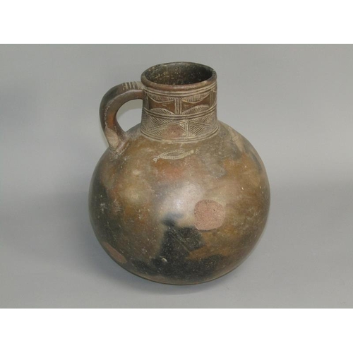 286 - A Medieval pottery jug with incised neck decoration and simple motifs to the shoulder, partially gla... 