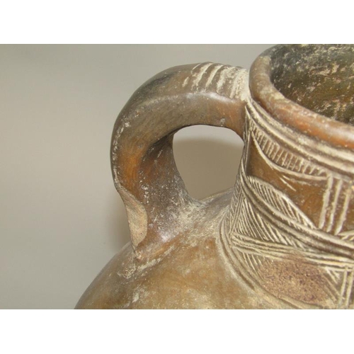 286 - A Medieval pottery jug with incised neck decoration and simple motifs to the shoulder, partially gla... 