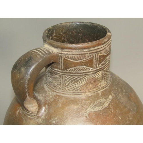 286 - A Medieval pottery jug with incised neck decoration and simple motifs to the shoulder, partially gla... 