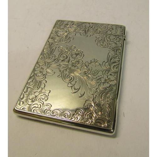 213 - A mid Victorian silver visiting card case chased with scrolling leaf and flowers, makers mark for Sa... 