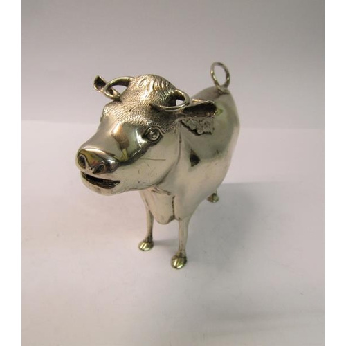 215 - A silver cow creamer, makers mark for Reid & Sons Ltd, London 1962, 5.2ozt, 15cm w.