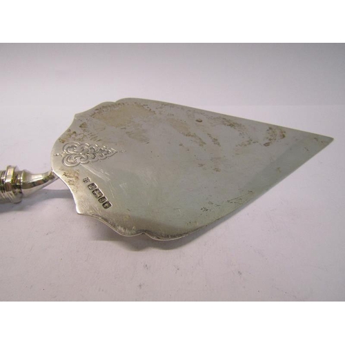 217 - A late Victorian silver serving trowel, chased with scrolling leaf and having a white bone handle, m... 