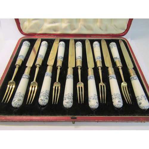 227 - A boxed set of George III dessert knives and forks with silver blades and prongs and having ceramic ... 