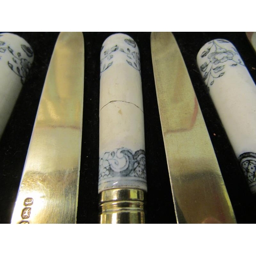 227 - A boxed set of George III dessert knives and forks with silver blades and prongs and having ceramic ... 