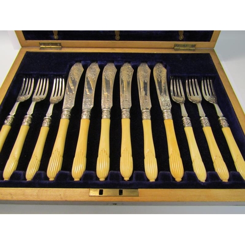 228 - An Edwardian canteen of twenty four fish knives and forks with bone handles, silver blades and prong... 