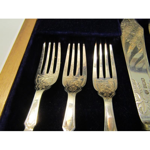 228 - An Edwardian canteen of twenty four fish knives and forks with bone handles, silver blades and prong... 