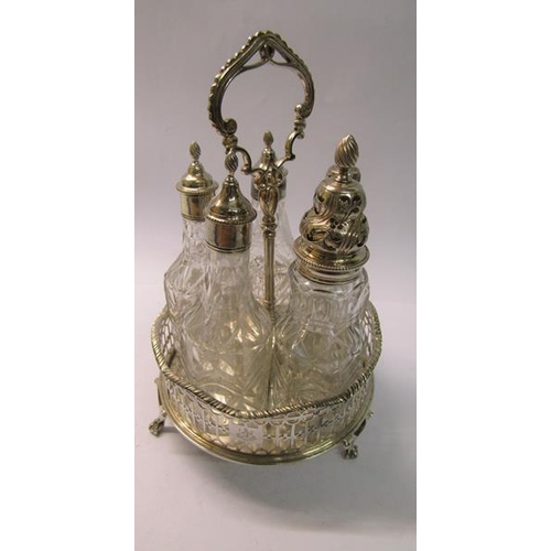 231 - A silver George III three bottle cruet stand with central carrying handle in a pierced circular fram... 