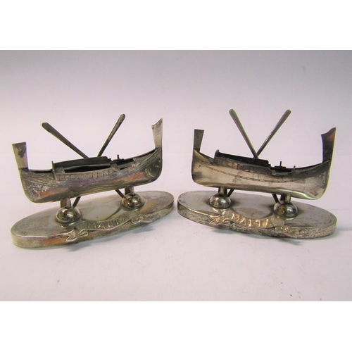 162 - A pair of Maltese silver menu card holders in the form of  boats, each with two oars supported on ov... 