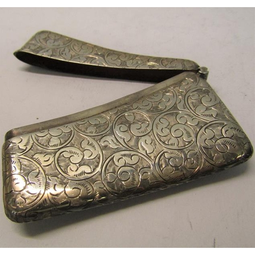 180 - A late Victorian visiting card case of curved form with hinged cover, chased with leaf and scrollwor... 