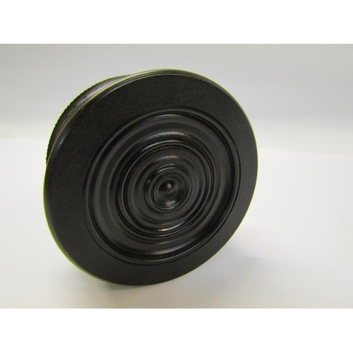 69 - A Vulcanite ebony circular box with circular pictorial classical panel to the lid, 7cm diam.