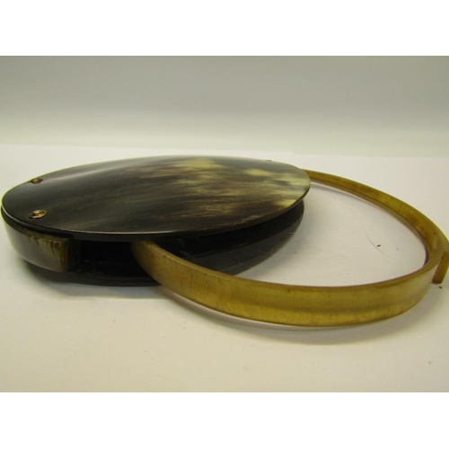 70 - A horn magnifying glass with a 10cm diam lens which folds into the case.