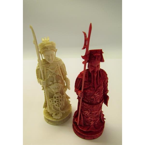 73 - Two 19c Chinese carved ivory chess pieces, both in the form of warriors, one white and one red stain... 