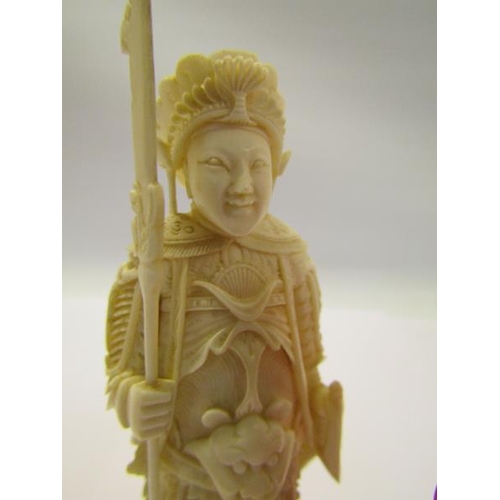 73 - Two 19c Chinese carved ivory chess pieces, both in the form of warriors, one white and one red stain... 